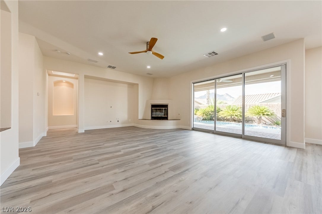 Sliding glass doors connect a generous living space to the backyard pool deck.