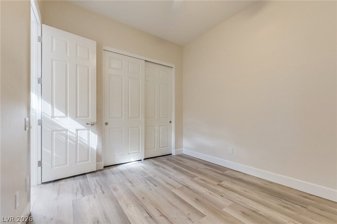 Gleaming wood-inspired flooring and clean white trim define this versatile room.