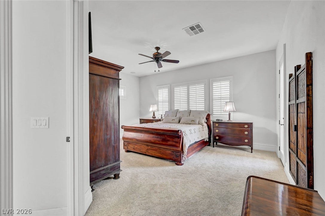 1116 Golden Age Court, Las Vegas, NV 89144 Plentiful natural light and soft carpeting define this inviting bedroom space.