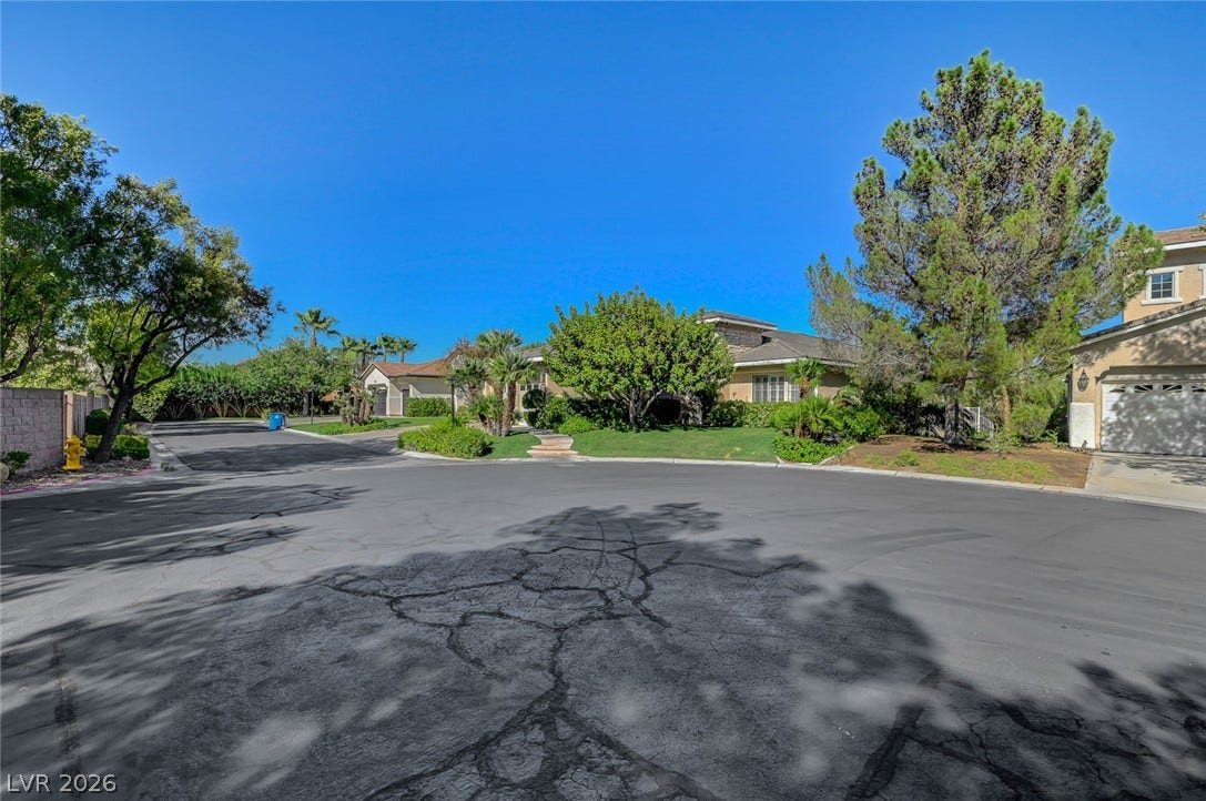 1116 Golden Age Court, Las Vegas, NV 89144 Mature trees frame the paved street leading toward this quiet suburban cul-de-sac neighborhood.