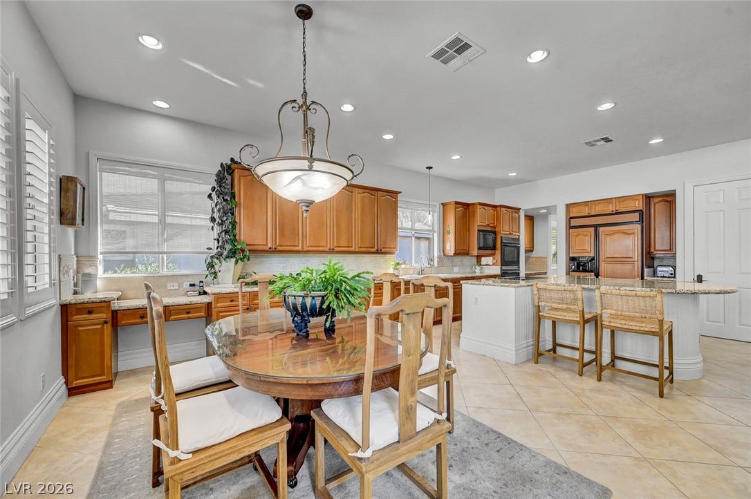 1116 Golden Age Court, Las Vegas, NV 89144 Custom cabinetry anchor this open-concept kitchen and dining area.