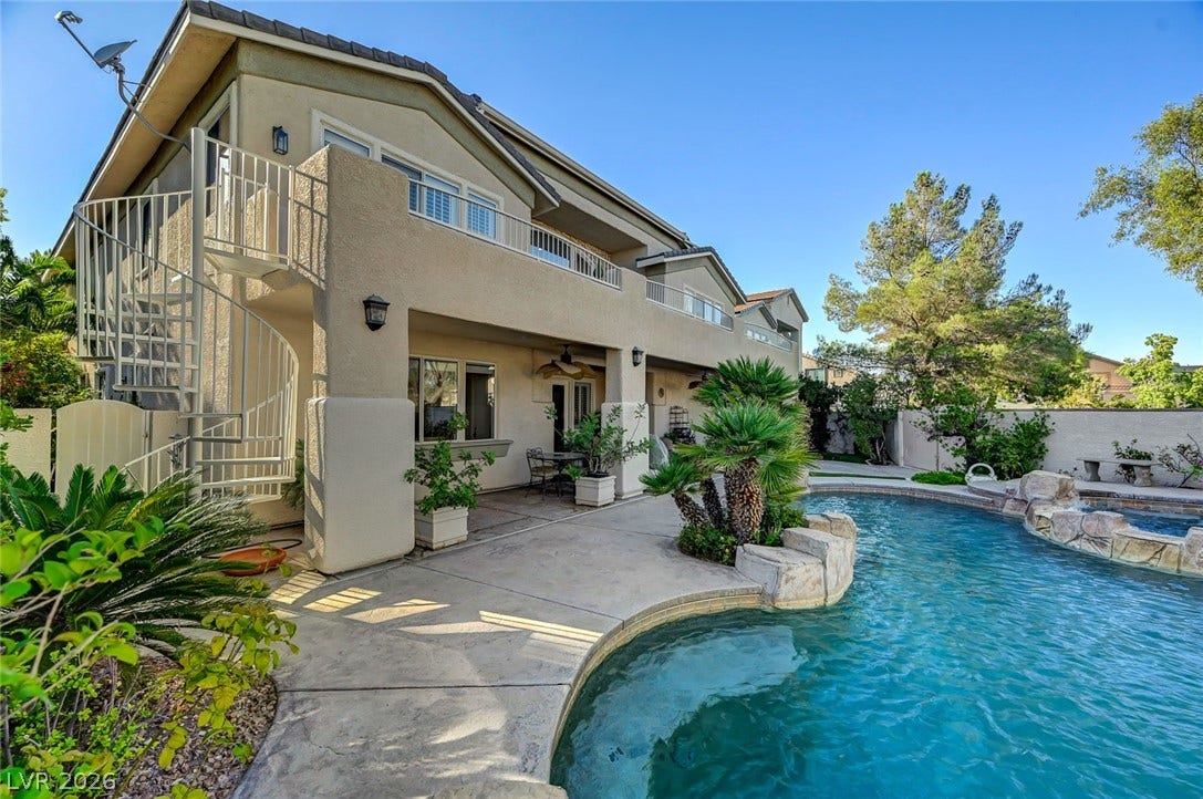 1116 Golden Age Court, Las Vegas, NV 89144 Shimmering waters sit alongside structured stone accents under clear desert skies.