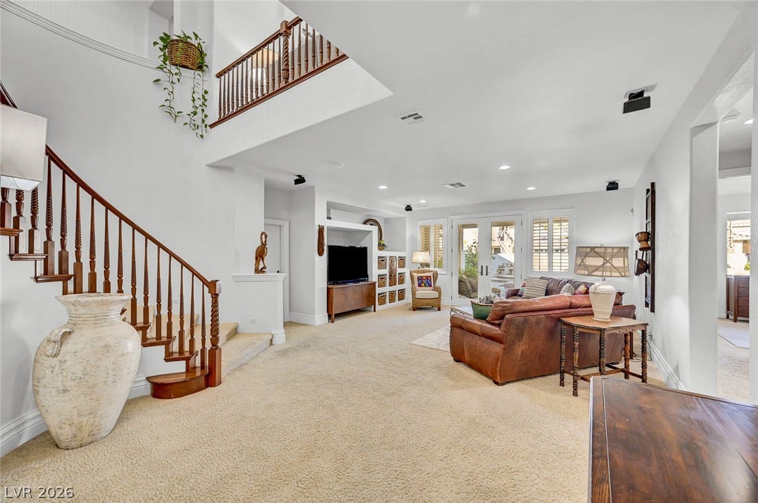 1116 Golden Age Court, Las Vegas, NV 89144 Gleaming wooden balustrades and an airy overhead overlook define this soaring, multi-level living area.