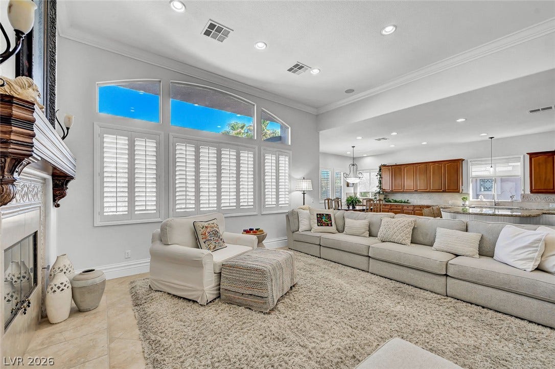 1116 Golden Age Court, Las Vegas, NV 89144 Crown molding and soaring ceilings elevate this open living area featuring plantation shutters.