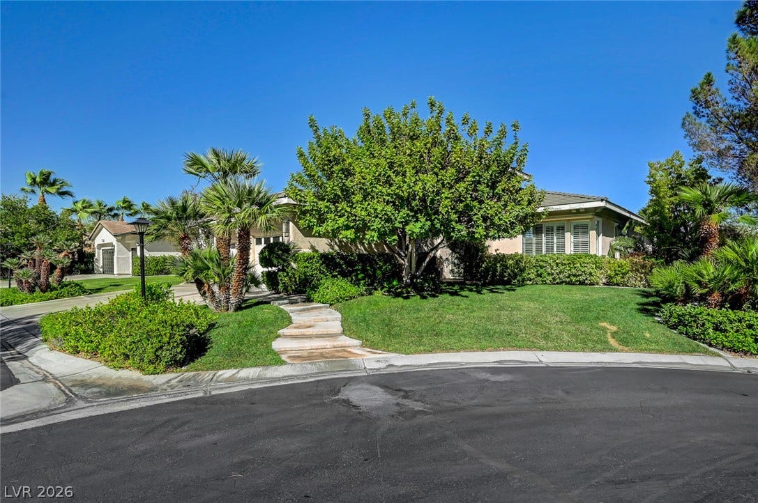 1116 Golden Age Court, Las Vegas, NV 89144 Lush landscaping and a curved stone pathway enhance the curb appeal of this suburban home.