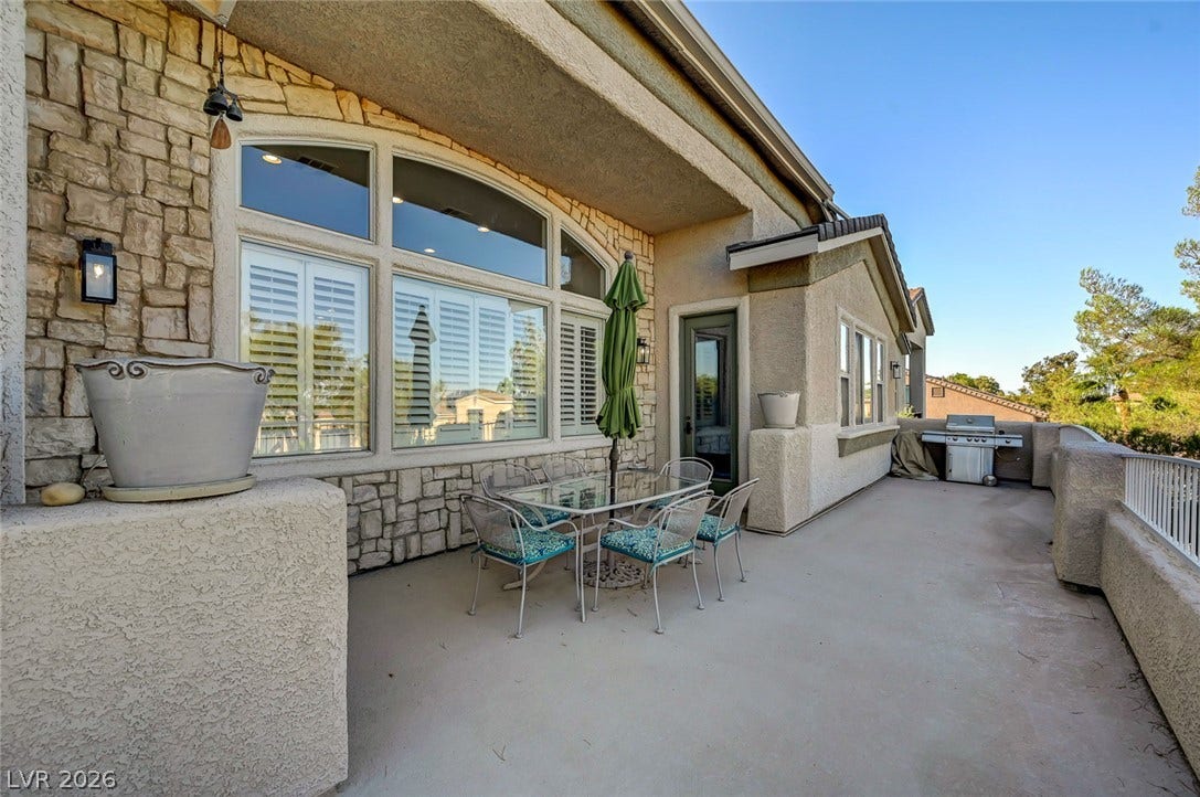 1116 Golden Age Court, Las Vegas, NV 89144 Stone accents and a covered balcony space enhance the outdoor entertainment area.