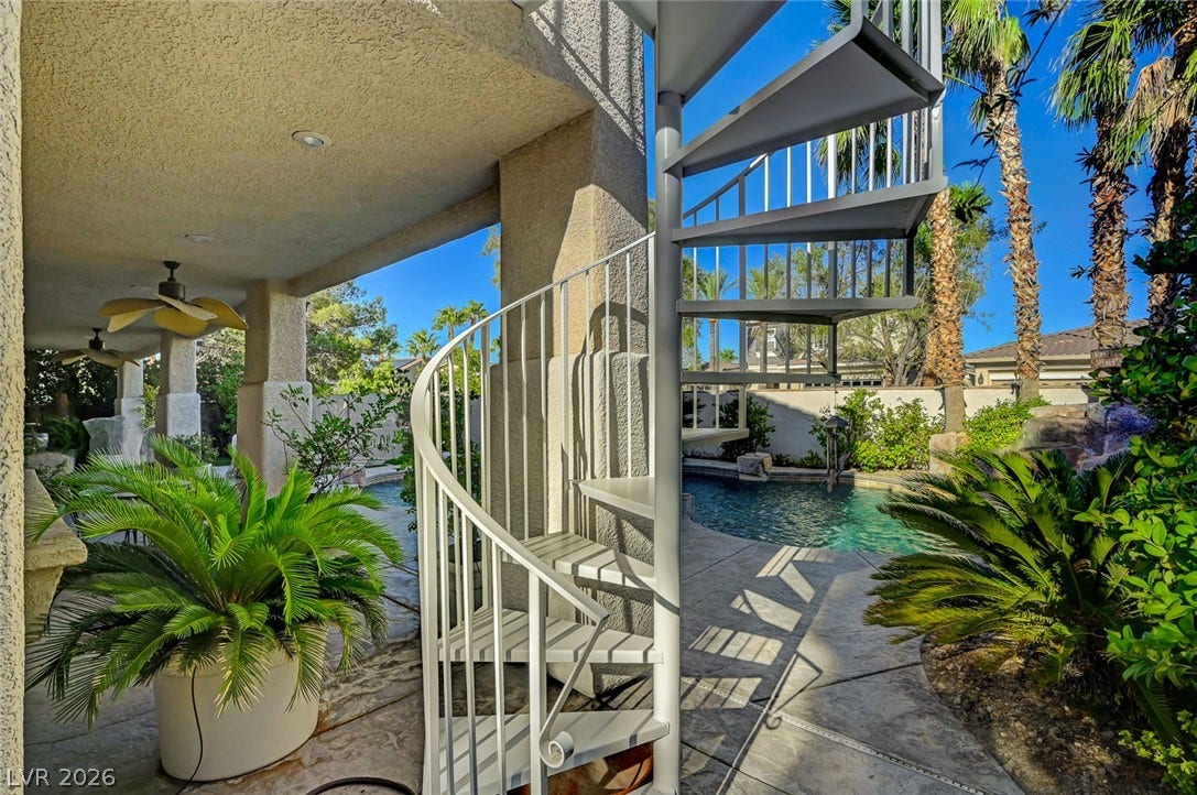 1116 Golden Age Court, Las Vegas, NV 89144 A metal spiral staircase connects the covered patio to the upper level beside the pool.