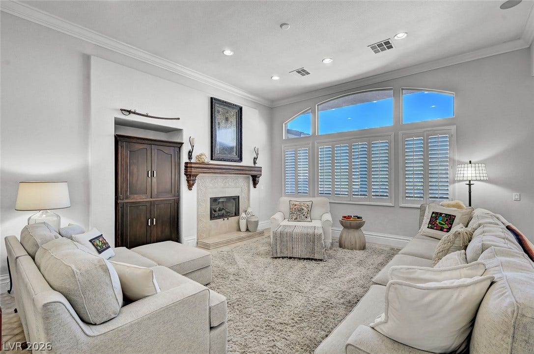 1116 Golden Age Court, Las Vegas, NV 89144 High ceilings and arched transom windows elevate this living space with a handsome fireplace.