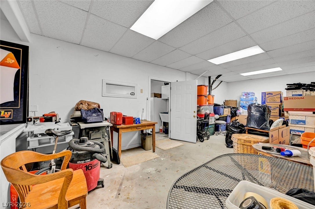 1116 Golden Age Court, Las Vegas, NV 89144 An expansive basement workspace offers abundant concrete floor area for hobbies and storage.