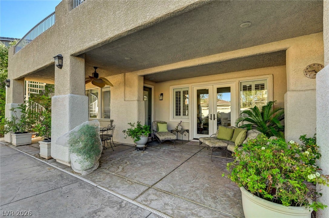 1116 Golden Age Court, Las Vegas, NV 89144 Shaded concrete patio features textured stucco columns and elegant French doors.