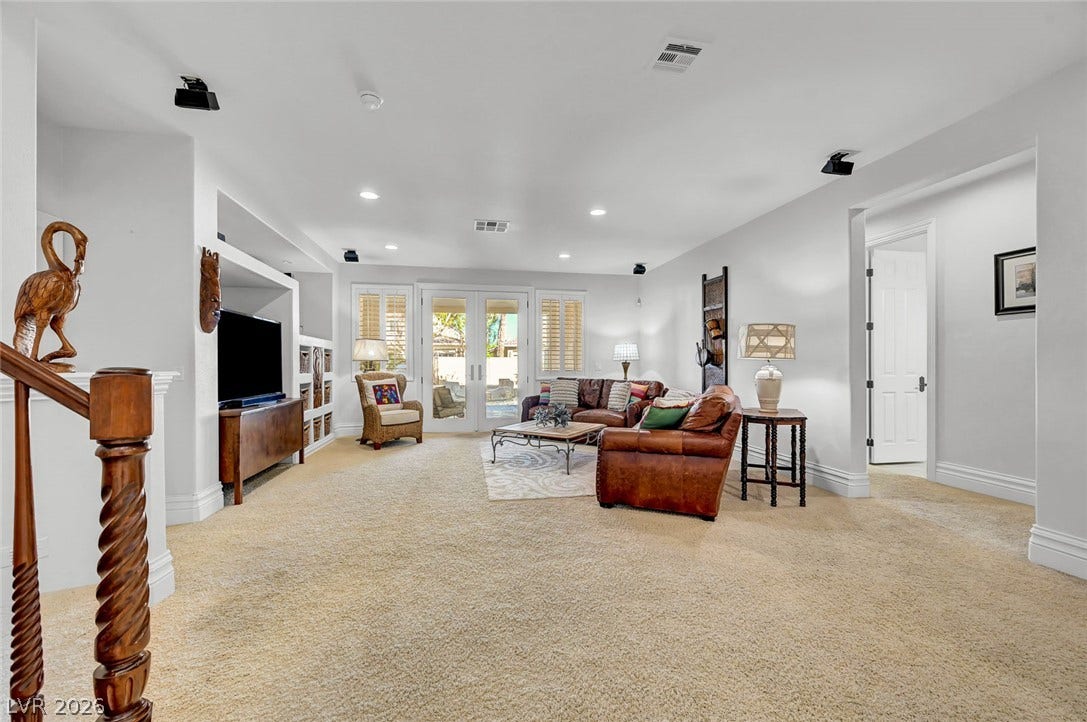 1116 Golden Age Court, Las Vegas, NV 89144 An open living space highlights plush carpeting, recessed lighting, and glass doors to the backyard.