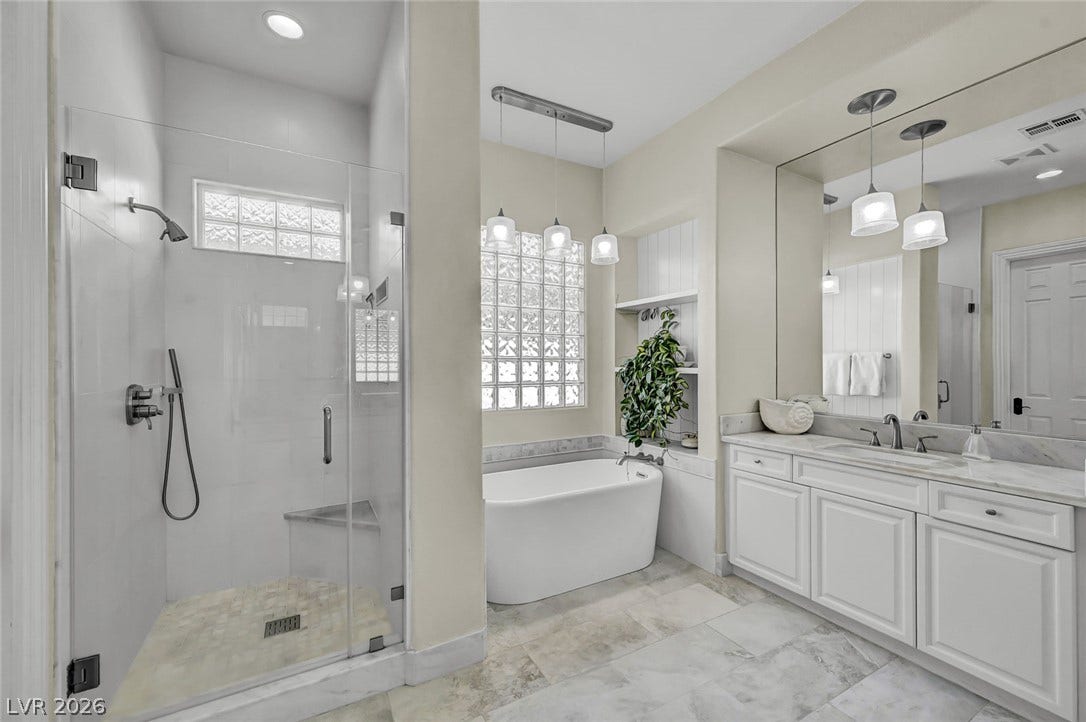 1116 Golden Age Court, Las Vegas, NV 89144 Glass blocks accent the freestanding tub and tiled shower stall in this airy bathroom.