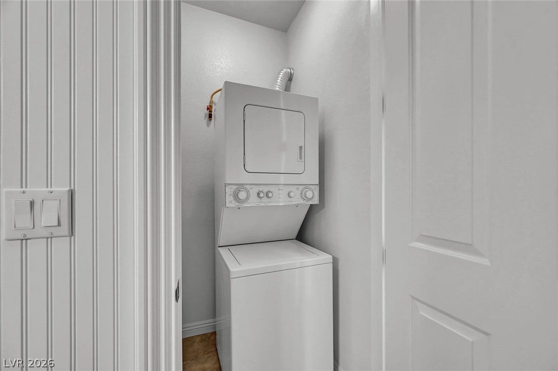 1116 Golden Age Court, Las Vegas, NV 89144 An efficient laundry closet features a stacked washer and dryer setup. Located in the basement bathroom.