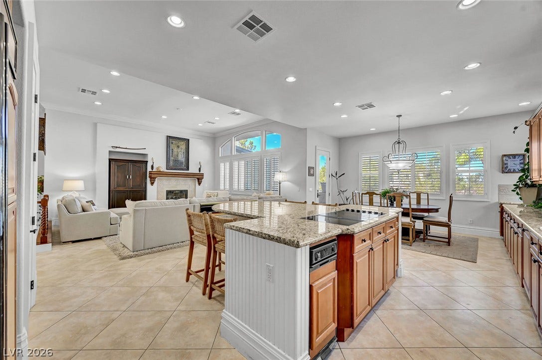 1116 Golden Age Court, Las Vegas, NV 89144 An open floorplan seamlessly connects the granite -countertop kitchen island with the living and dining areas.