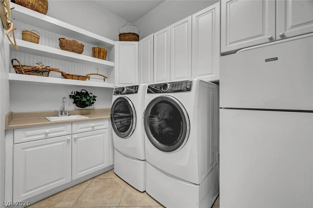1116 Golden Age Court, Las Vegas, NV 89144 Ample cabinetry and functional utility space define this well-appointed laundry room with beautiful flooring.