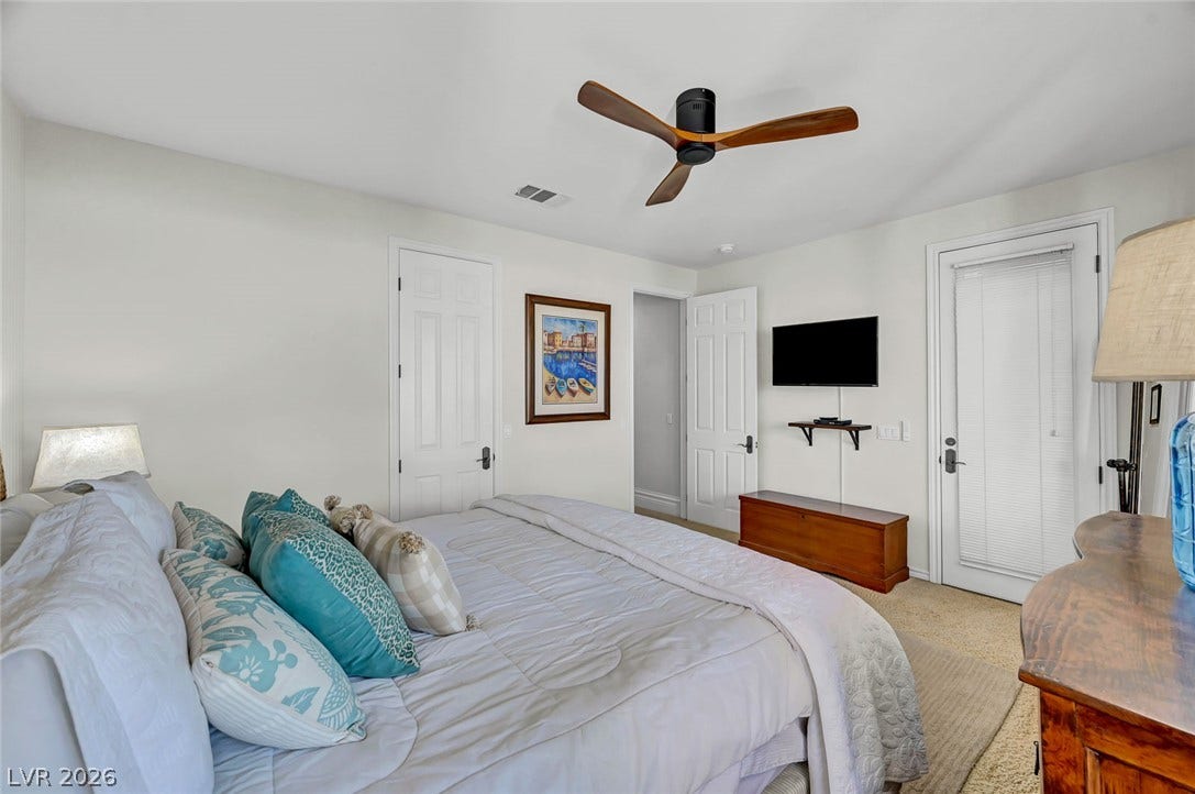 1116 Golden Age Court, Las Vegas, NV 89144 Soft carpet and smooth plaster walls define this comfortable, light-filled sleeping space.