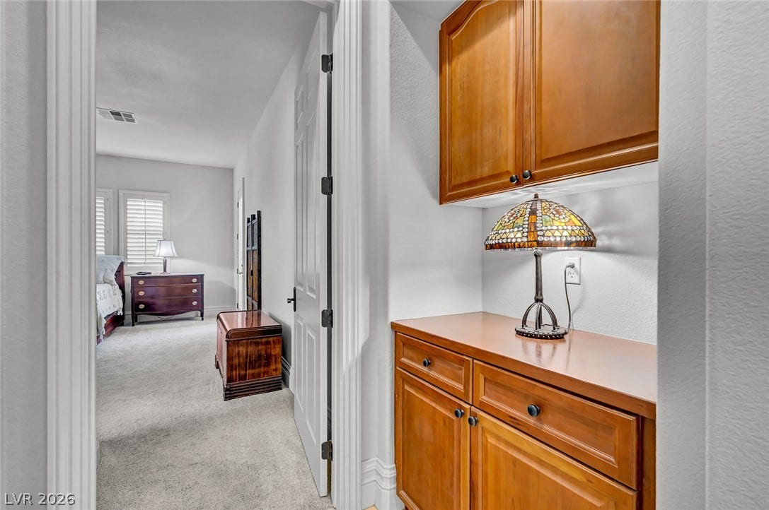 1116 Golden Age Court, Las Vegas, NV 89144 Gleaming built-in cabinetry provides convenient storage adjacent to a plush carpeted hallway.