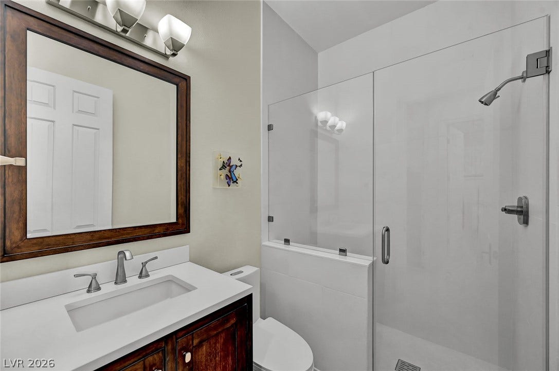 1116 Golden Age Court, Las Vegas, NV 89144 Clean lines and a glass-enclosed shower define this streamlined bathroom design.