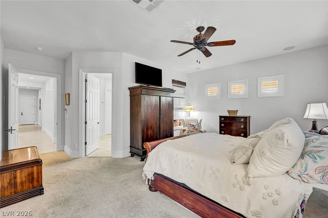 1116 Golden Age Court, Las Vegas, NV 89144 A spacious bedroom features soft wall-to-wall carpeting and raised baseboards.