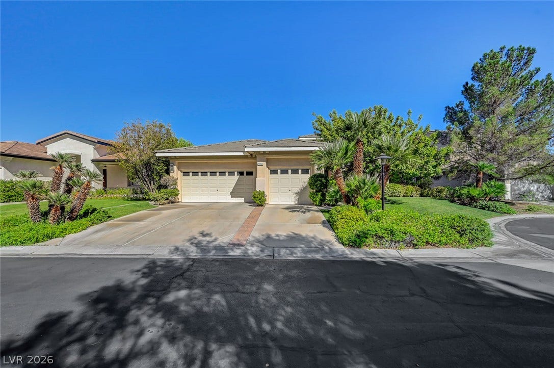 1116 Golden Age Court, Las Vegas, NV 89144 Lush tropical landscaping frames the concrete driveway and multi-car garage of this single-level home with a walk down basement.