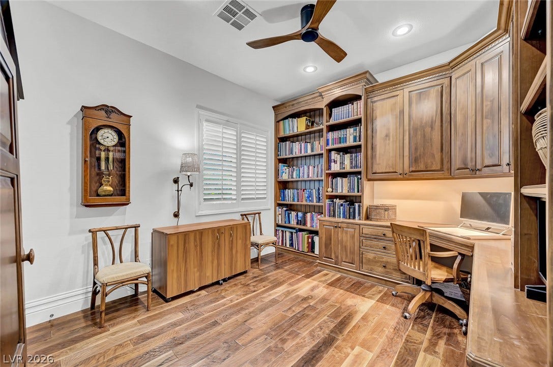 1116 Golden Age Court, Las Vegas, NV 89144 Gleaming hardwood floors and extensive custom built-ins define this functional home office workspace.