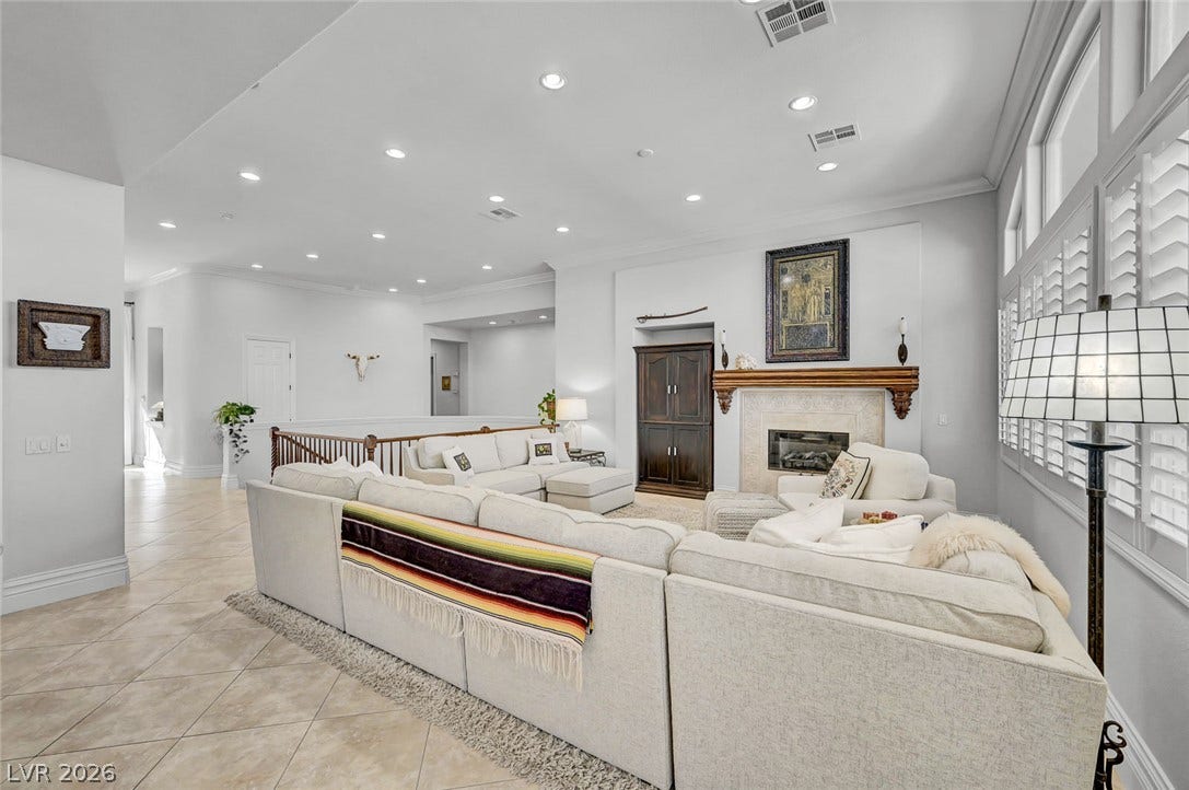 1116 Golden Age Court, Las Vegas, NV 89144 Recessed lighting, tile flooring, and a fireplace with a mantel define this airy living space.