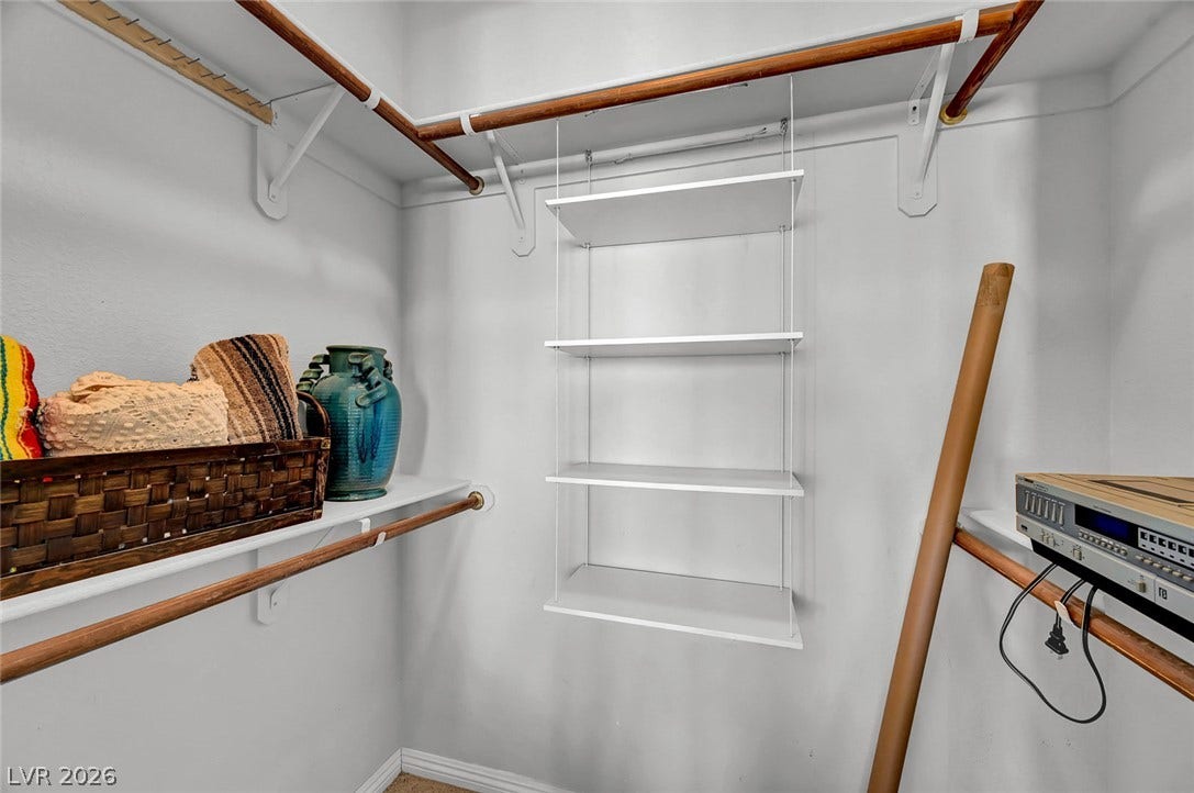 1116 Golden Age Court, Las Vegas, NV 89144 A spacious walk-in closet includes built-in shelving and hanging rods.