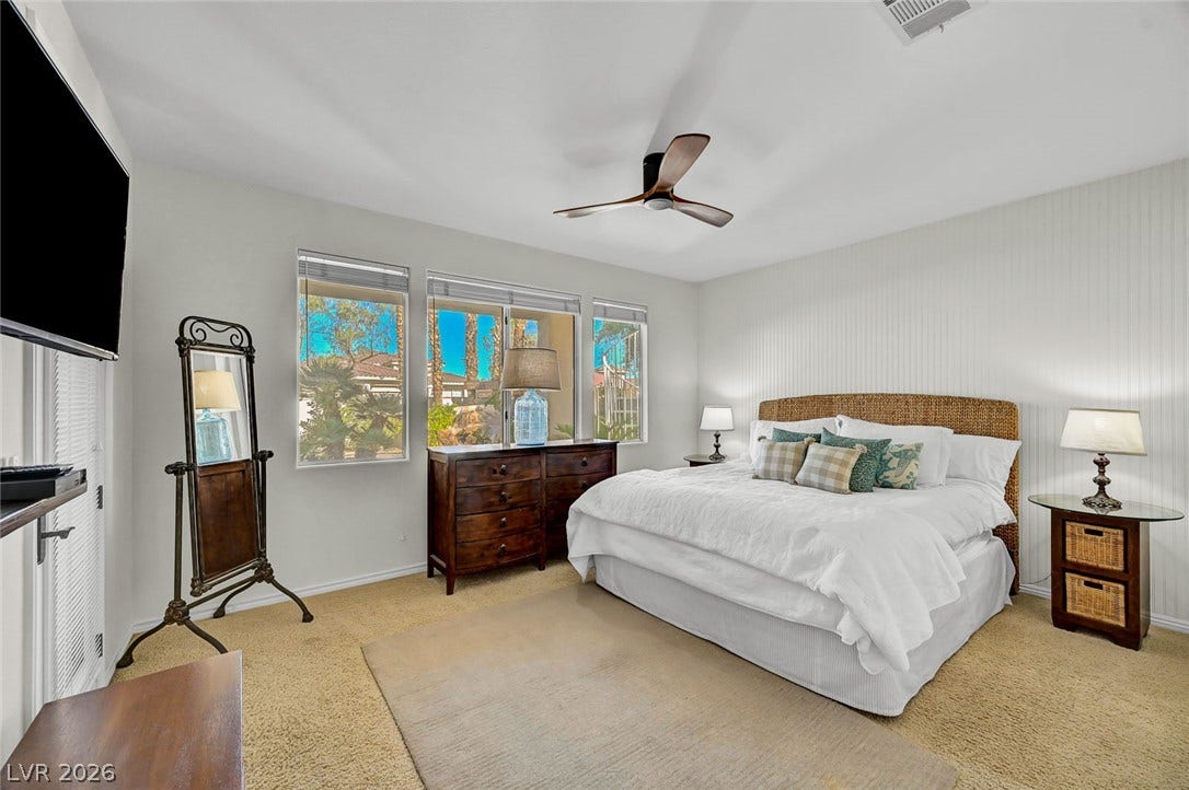 1116 Golden Age Court, Las Vegas, NV 89144 Generous windows frame neighborhood views in this light-filled bedroom with plush carpeting.