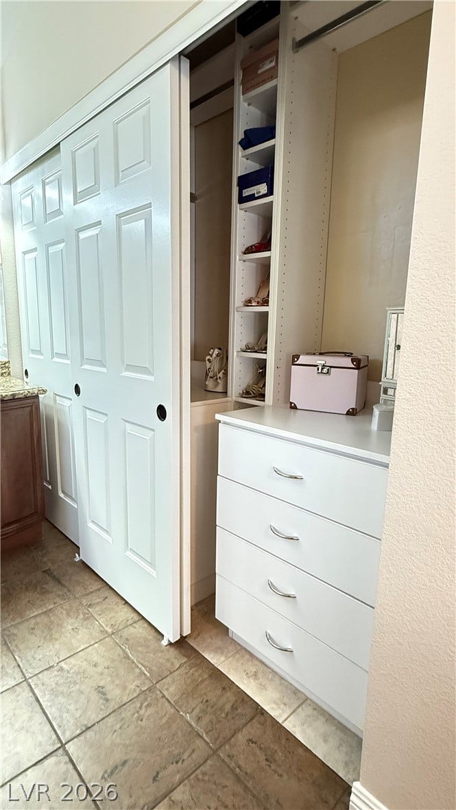 2408 Pebble Springs Court, Henderson, NV 89074 Custom Closet; 6 drawers, 2 pull out lower shelves, 5 adjustable hanging rods for clothes, shoe/purse cubbies, retractable rod for dry cleaning or bathrobe