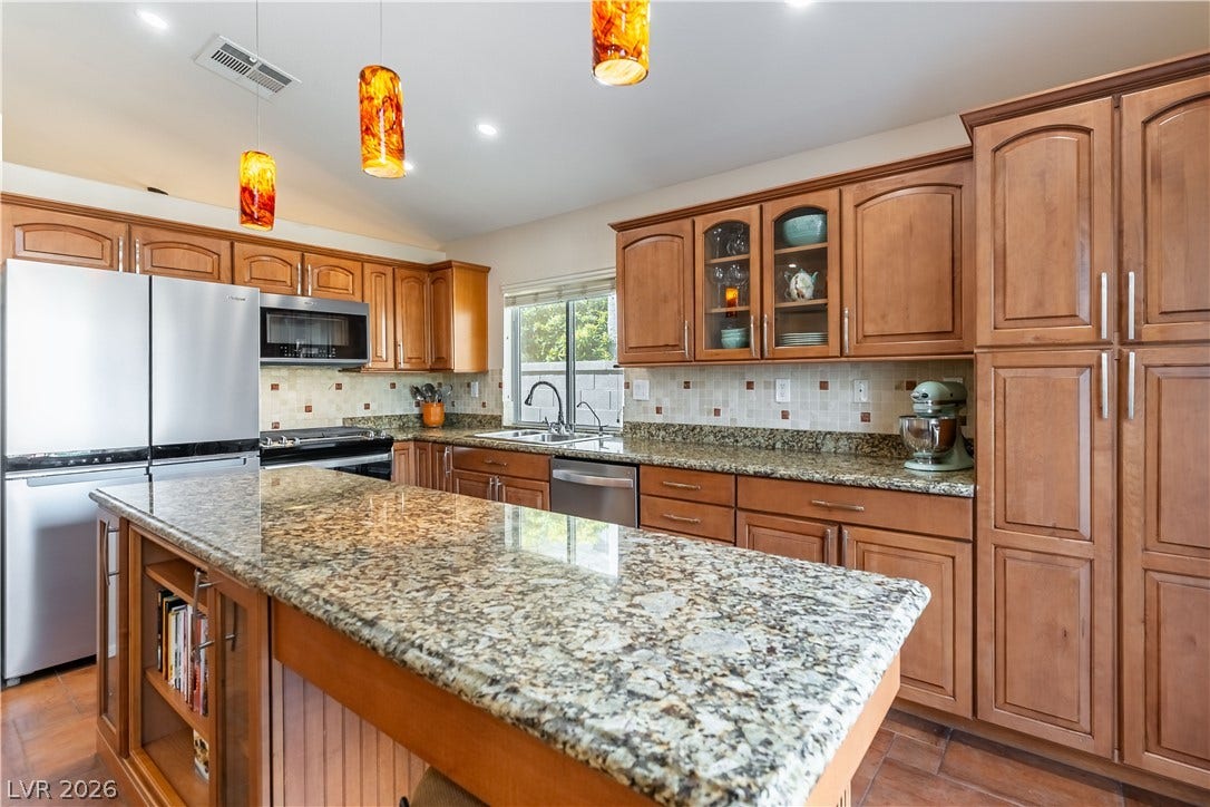 2408 Pebble Springs Court, Henderson, NV 89074 Custom Cabinets, features soft-close drawers, lazy susan, pantry, roll-out shelves inside pantry and lower cabinets