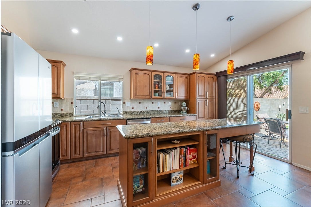2408 Pebble Springs Court, Henderson, NV 89074 Chocolate Sundae pendant lighting with dimmers centered above granite island
