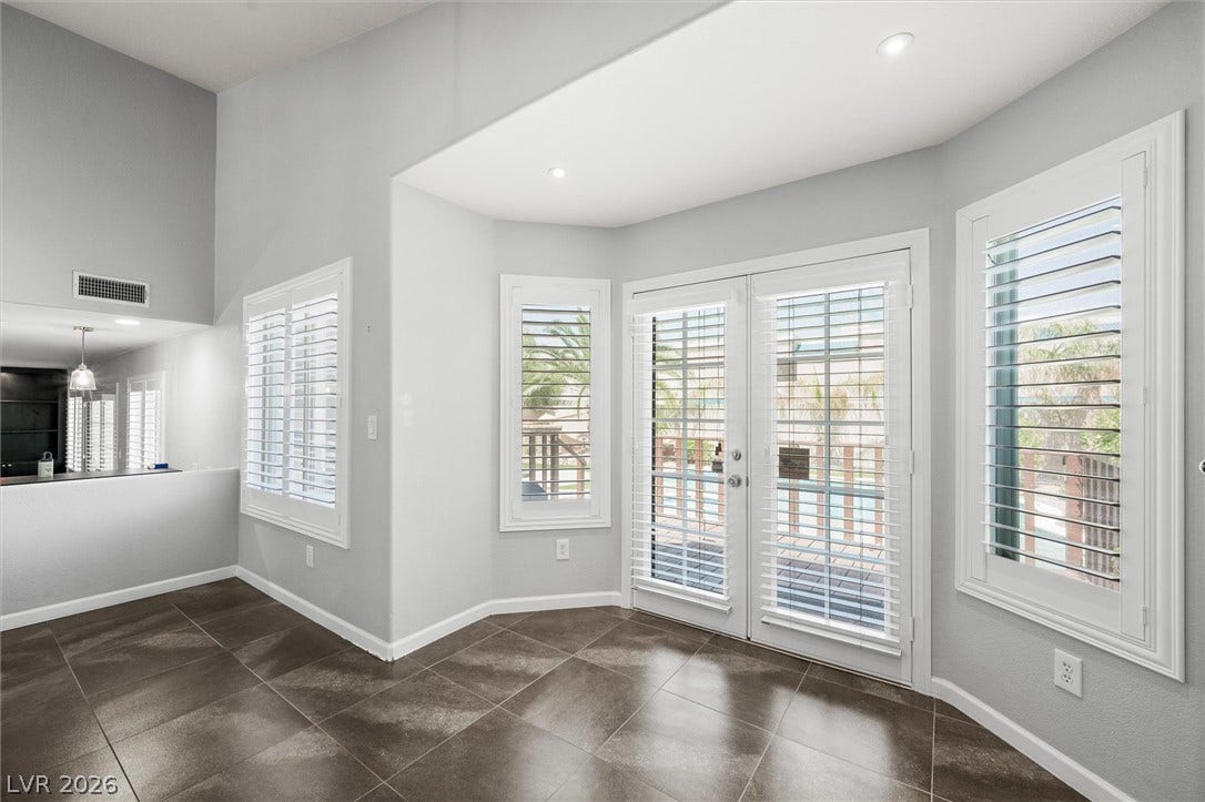 1584 Bozeman Drive, Henderson, NV 89012 French doors open to the outdoors from a tiled space with plantation shutters.