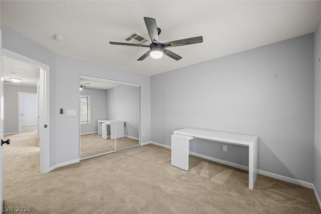 1584 Bozeman Drive, Henderson, NV 89012 Smooth carpeting and sliding mirrored closet doors anchor this versatile secondary bedroom space.
