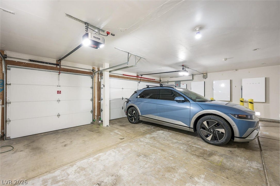 1584 Bozeman Drive, Henderson, NV 89012 A spacious garage features durable concrete flooring, multiple bays, and integrated electric vehicle charging setups.
