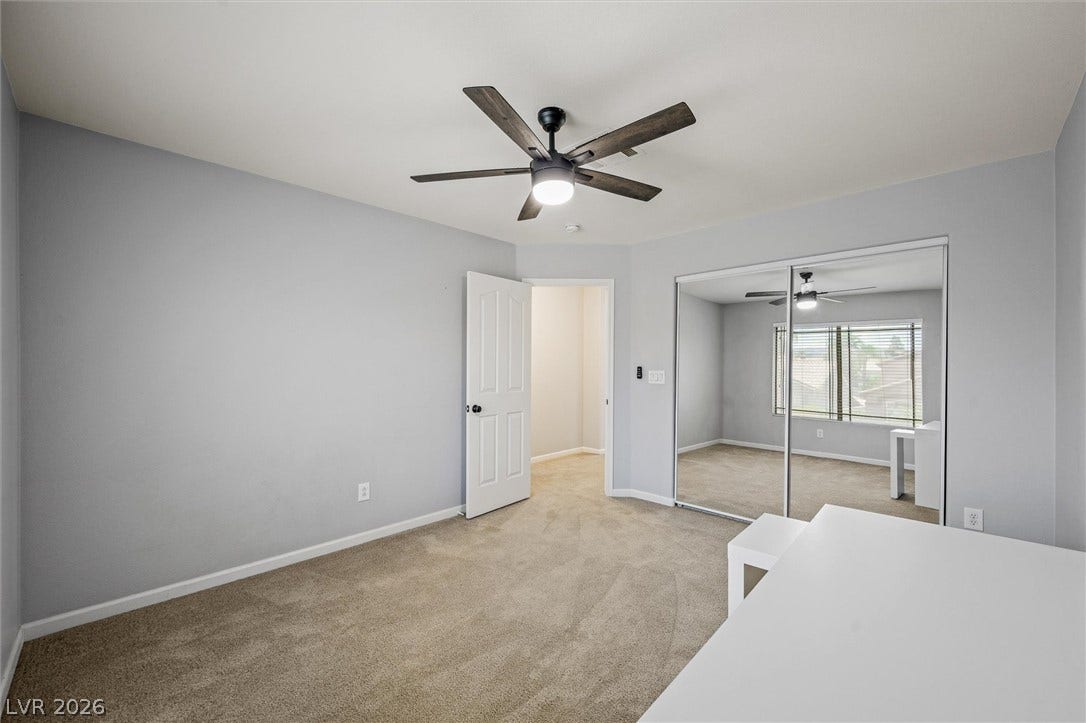 1584 Bozeman Drive, Henderson, NV 89012 Plush carpeting and mirrored sliding closet doors define this airy, light-filled bedroom.