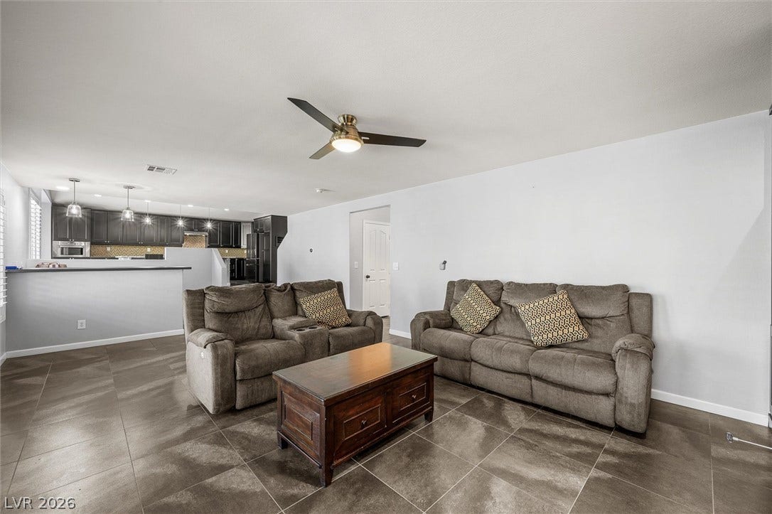 1584 Bozeman Drive, Henderson, NV 89012 Polished tile flooring and an open layout seamlessly connect the living area to the kitchen.