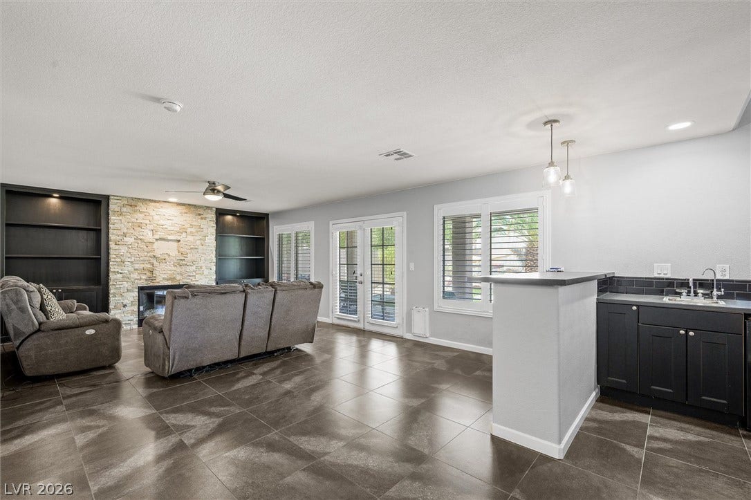 1584 Bozeman Drive, Henderson, NV 89012 Stone accents and modern tile flooring define this spacious open living area.