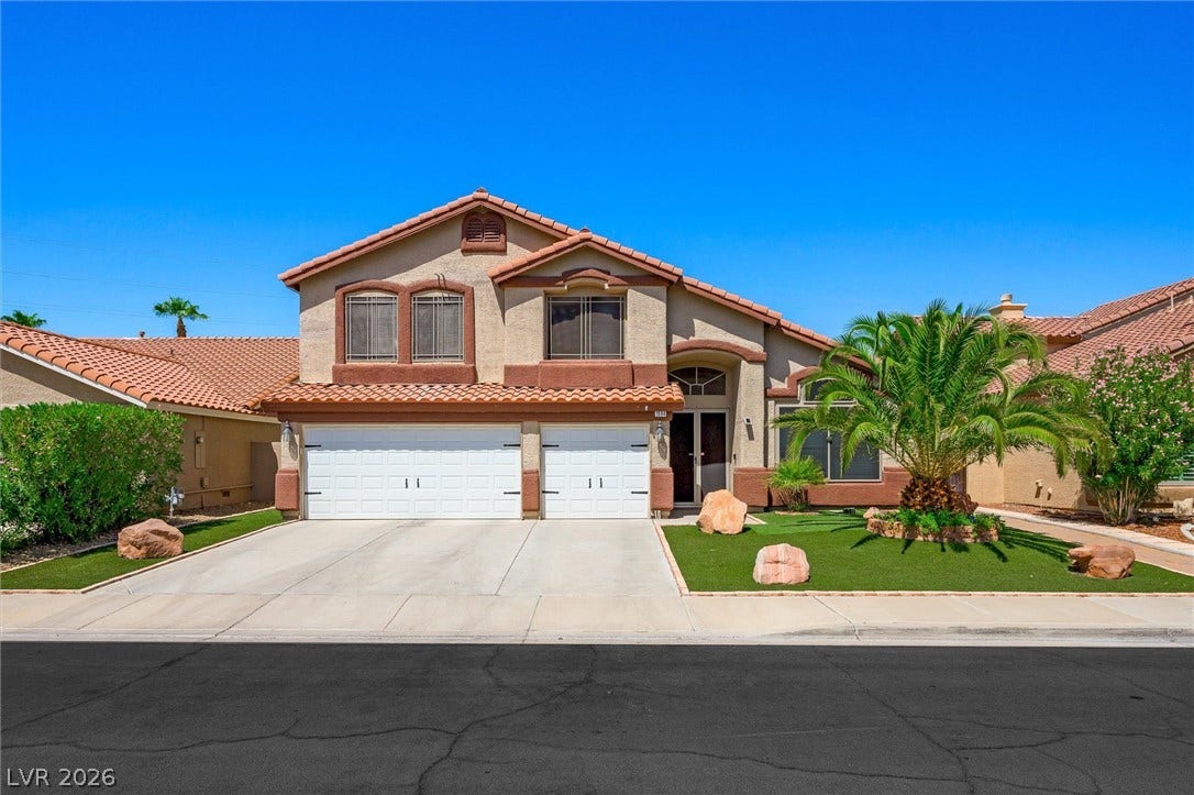 1584 Bozeman Drive, Henderson, NV 89012 Clay tile roofing and a wide concrete driveway frame this two-story Mediterranean-style residence.