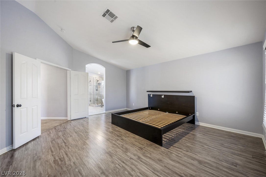 1584 Bozeman Drive, Henderson, NV 89012 Vaulted ceilings and wood-style flooring elevate this comfortable master bedroom suite.