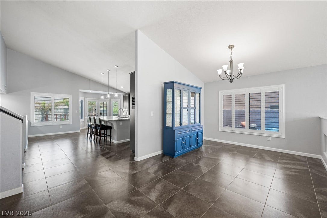 1584 Bozeman Drive, Henderson, NV 89012 Polished tile flooring and vaulted ceilings define this airy, open-concept dining space.