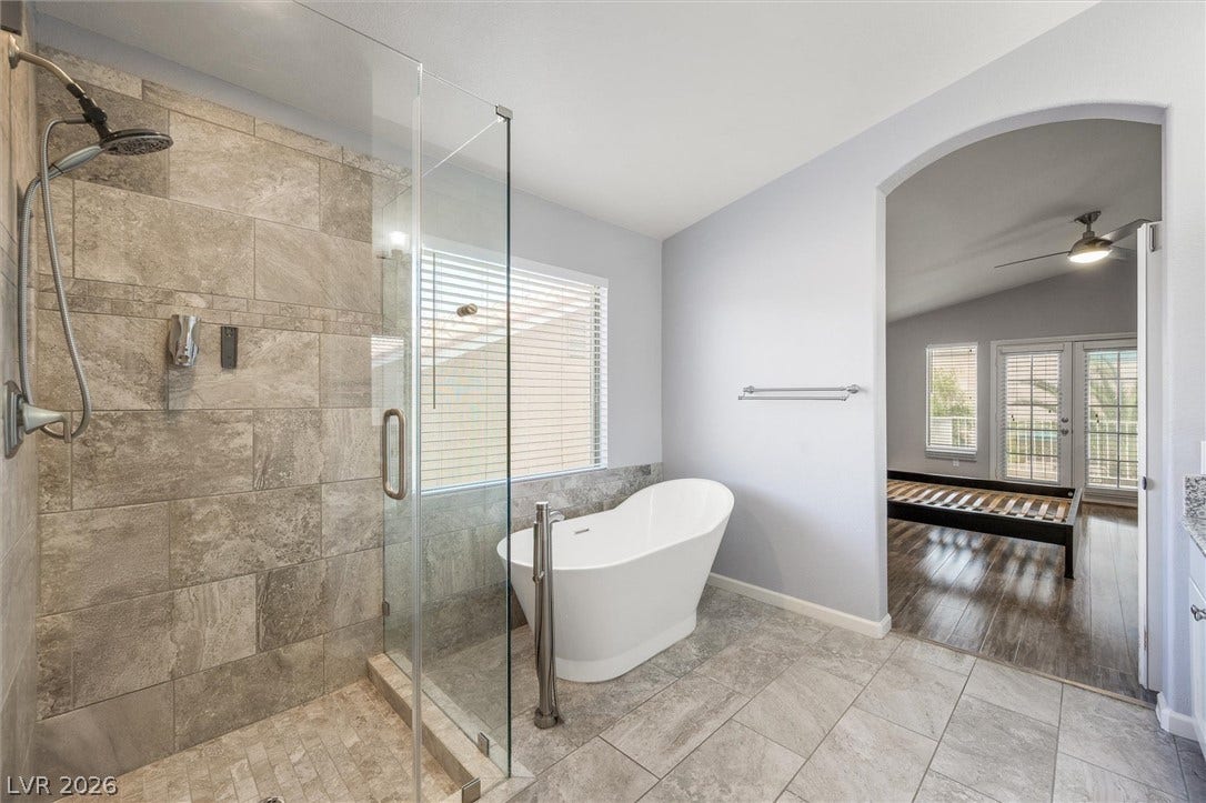 1584 Bozeman Drive, Henderson, NV 89012 A freestanding tub and tiled walk-in shower anchor this primary bathroom suite.