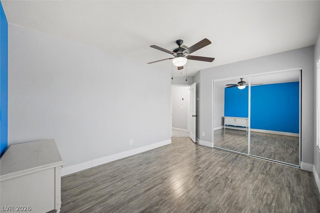 1584 Bozeman Drive, Henderson, NV 89012 Hardwood floors and large sliding mirrored doors define this versatile secondary bedroom space.