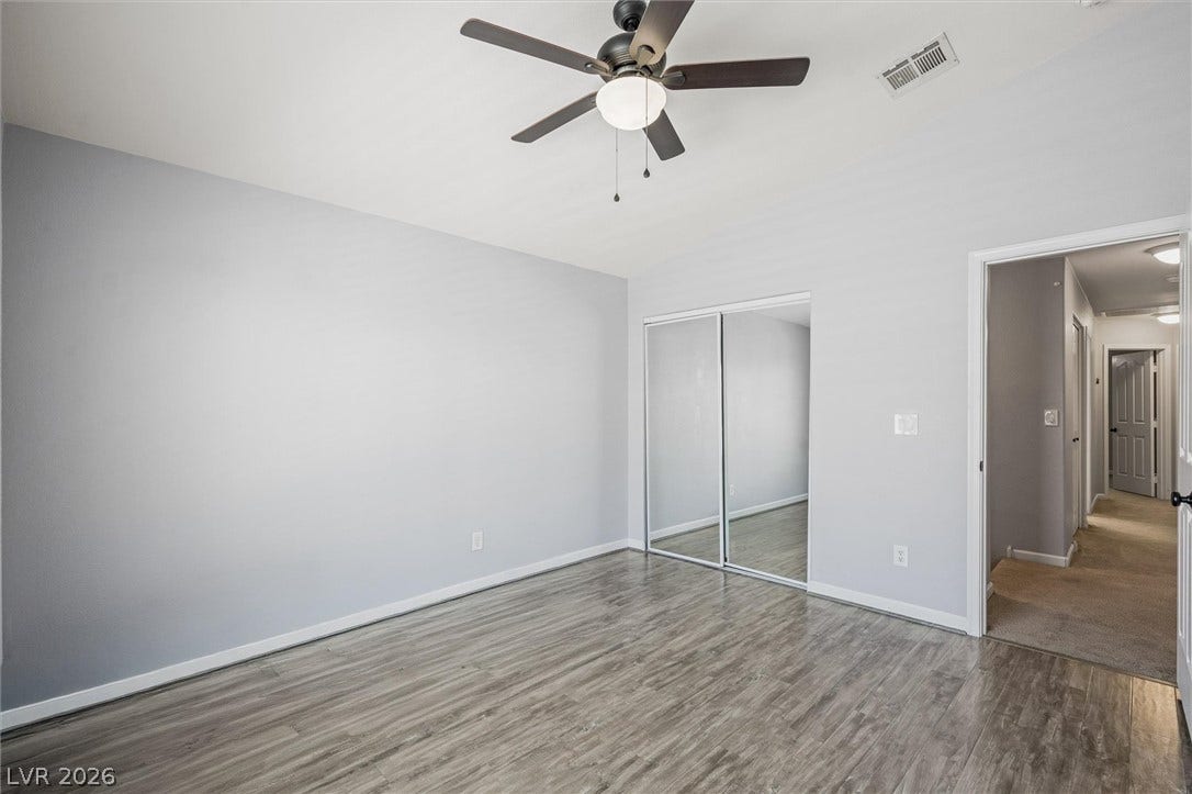 1584 Bozeman Drive, Henderson, NV 89012 Polished hard-surface flooring and mirrored closet doors enhance this modern bedroom.