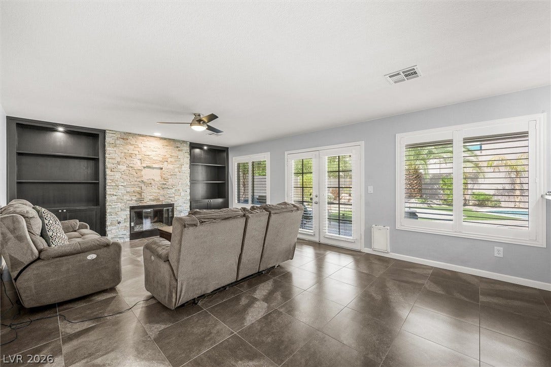 1584 Bozeman Drive, Henderson, NV 89012 An inviting stone fireplace anchors this living space, complete with durable tile flooring.