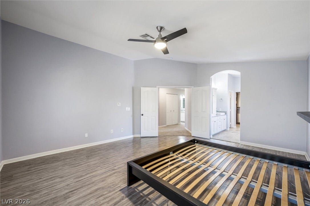 1584 Bozeman Drive, Henderson, NV 89012 Elegant wood-look flooring and vaulted ceilings define this peaceful primary retreat.