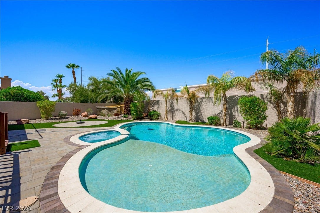 1584 Bozeman Drive, Henderson, NV 89012 Palm trees surround a custom pool and integrated spa in this private backyard oasis.
