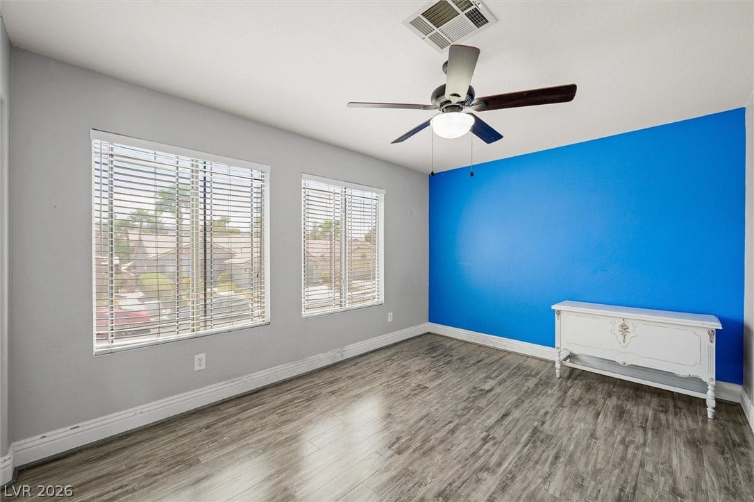1584 Bozeman Drive, Henderson, NV 89012 Wood flooring and dual windows define this versatile secondary bedroom space.