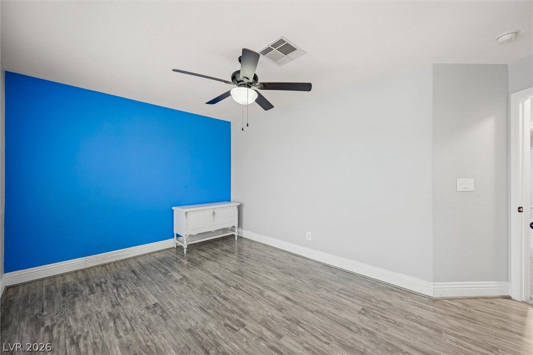1584 Bozeman Drive, Henderson, NV 89012 Smooth wood-look flooring and crisp white trim define this versatile secondary room.