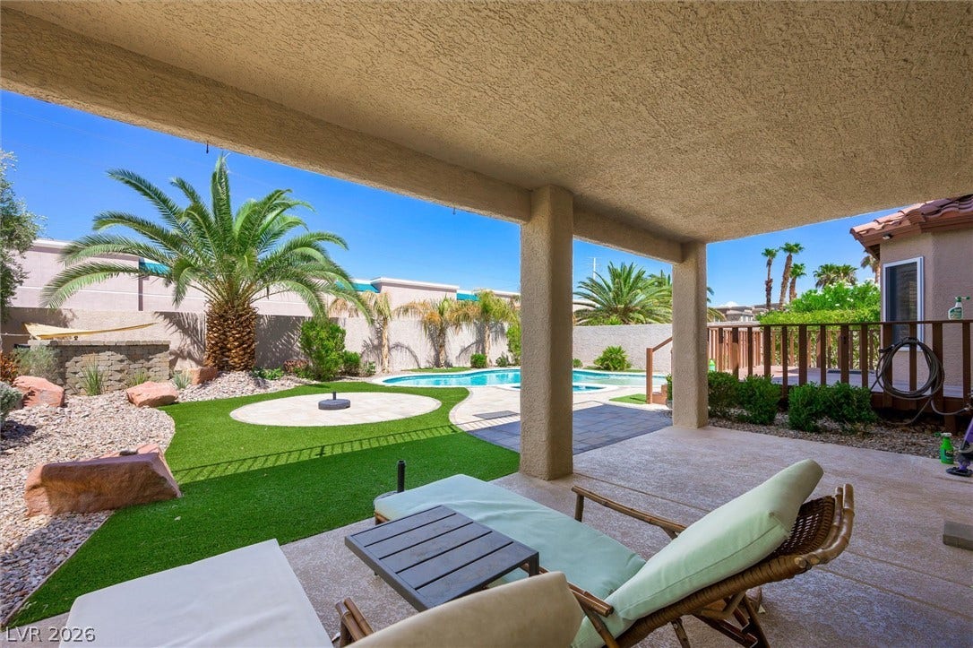 1584 Bozeman Drive, Henderson, NV 89012 A spacious covered patio overlooks a manicured backyard oasis featuring a sparkling swimming pool.