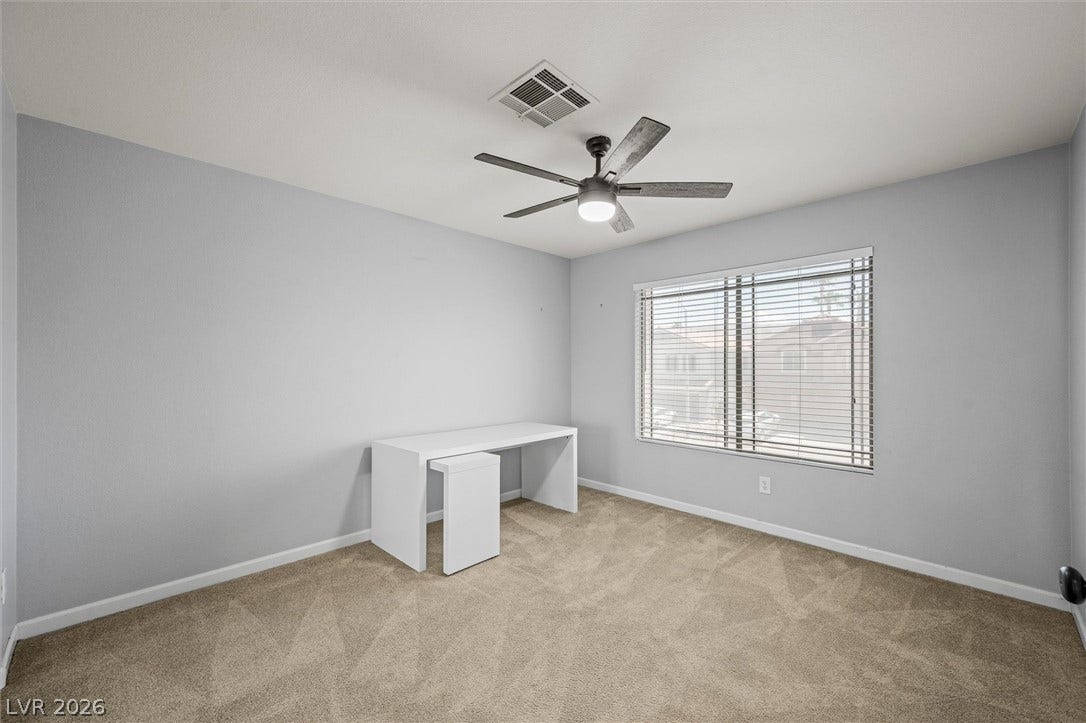 1584 Bozeman Drive, Henderson, NV 89012 A wide window illuminates this versatile secondary space featuring neutral carpeting.